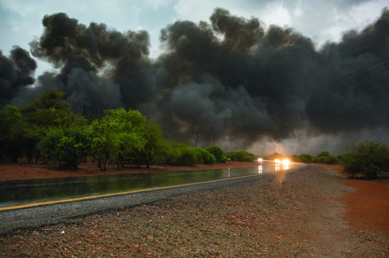 Burning on: The fire was later doused by downpours on Sunday night PICS: THALEFANG CHARLES