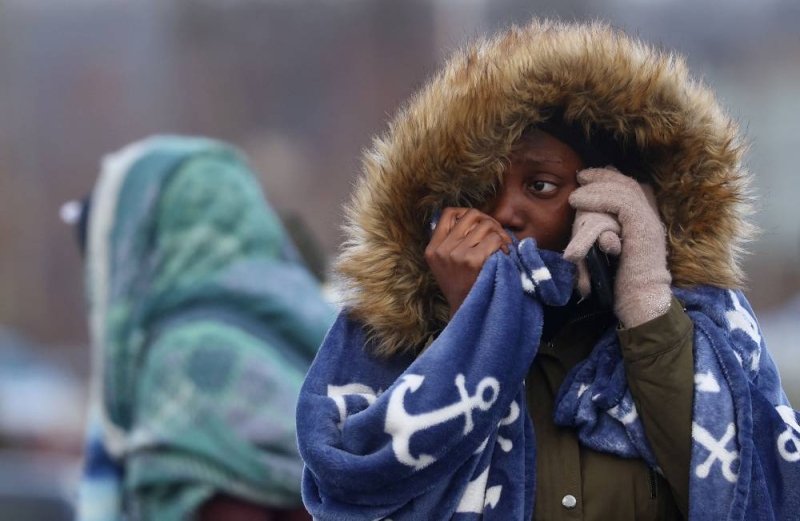 A woman from Western Africa cries while taking on the phone after fleeing Ukraine following the Russian invasion, at the border checkpoint in Medyka, Poland, February 28, 2022. REUTERS/Kai Pfaffenbach