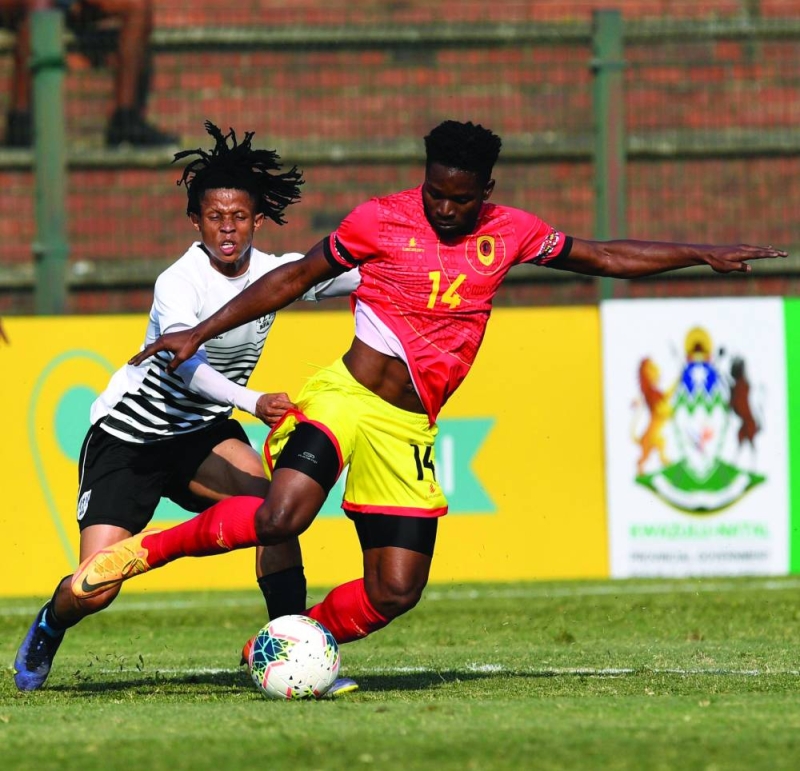 Zebras midfielder, Mothusi Cooper (in white) battling for the ball with an Angolan player PIC: COSAFA
