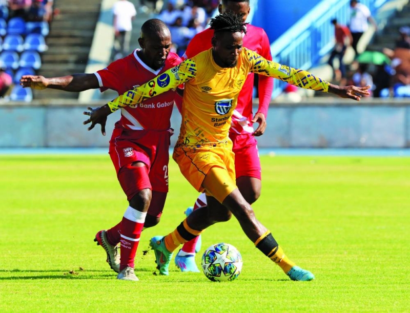 Thatayaone Ramatlapeng (red) battling for the ball with Segolame Boy (yellow) during Gaborone derby on Saturday PIC: PHATSIMO KAPENG