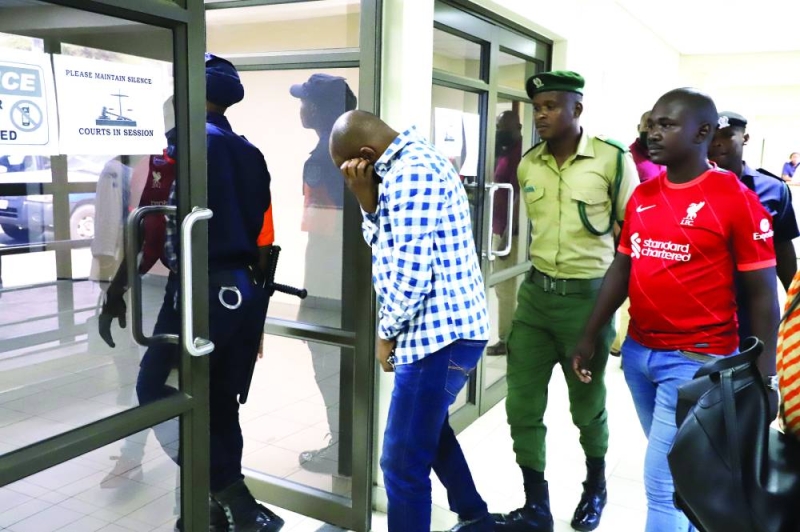 Gaboutlwelwe Modirelabangwe(hiding from the camera) arriving at Broadhurst Magistrates Court PIC: MORERI SEJAKGOMO