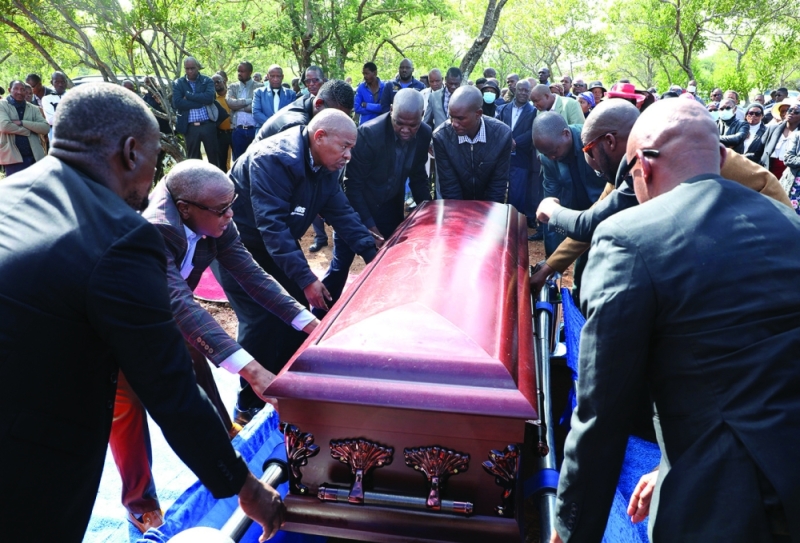 Former colleagues interring Motshidisi’s remains at his home village, Bokaa PIC: BOPA