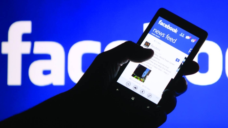 A smartphone user shows the Facebook application on his phone.