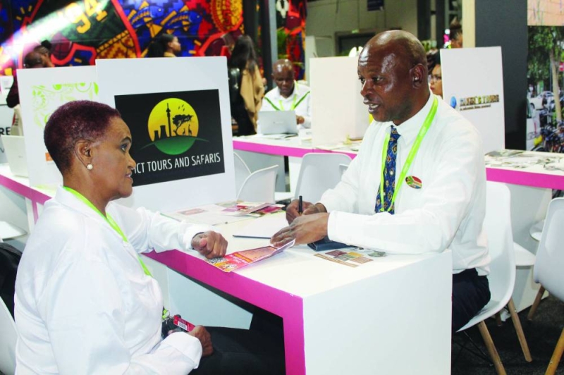 Sharing advice: Motsepe (right) at his booth at the ATI PIC: CHAKALISA DUBE