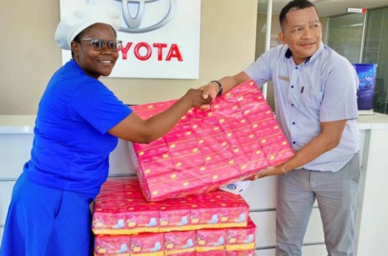 The choir's PRO Kelebeile receiving sanitary pads from Bamangwato Toyota general manager,Melvin Kruger.