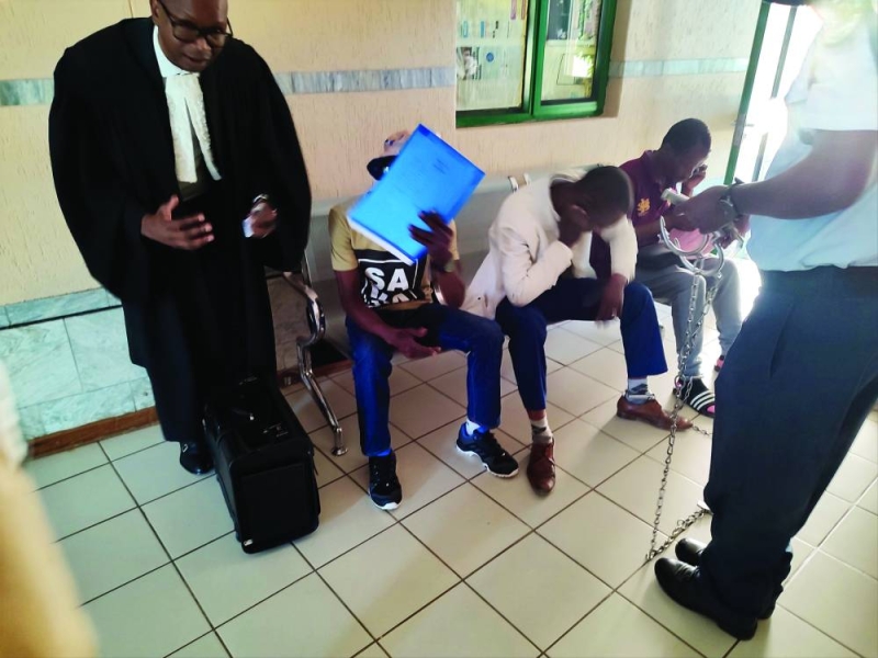 Ramolala Molefe and Lesego waiting to be whisked to prison PIC: INNOCENT SELATLHWA.