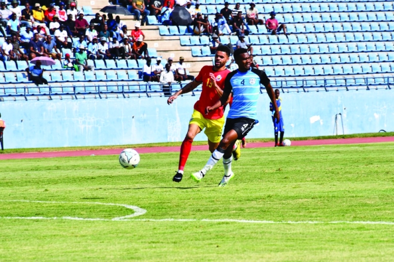 Ball watching: Mosha Gaolaolwe (right) tries to sherpherd the ball away from Mozambican opponent during yesterday’s encounter PIC: BFA