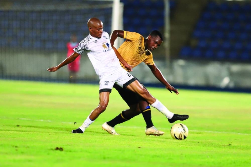 Tlamiso Gagoanngwe (White) of Gunners tussles for the ball with Mphoyamodimo Keipone (Yellow) of Notwane during the Debswana First Division South encounter played on Saturday night at the National Stadium PIC: KENNEDY RAMOKONE