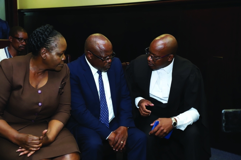 Morupisi and his wife in consultation with his attorney, Manewe at the High Court PIC: MORERI SEJAKGOMO