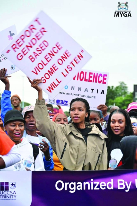 Lesego Chombo holding a placard.PIC.MYGA