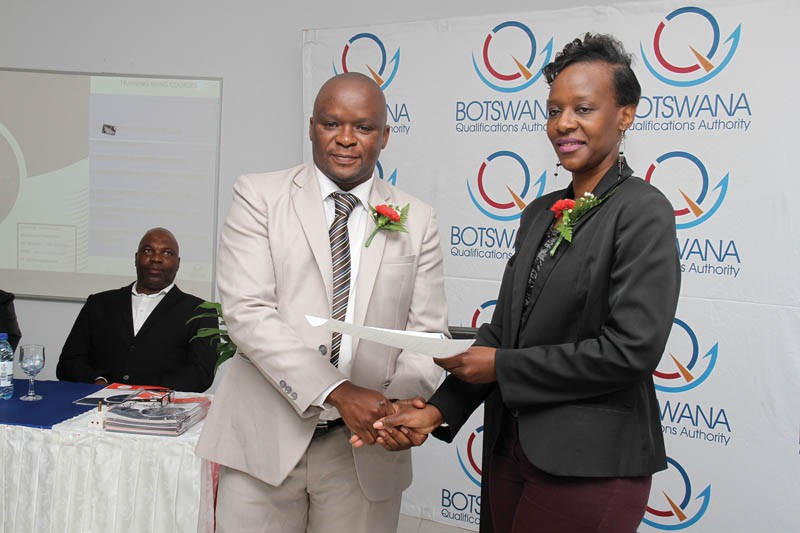 Waygard Security CEO Phenyo Gothaang receiving certificate from Sandra Pabalinga of BQA.PIC moreri sejakgomo
