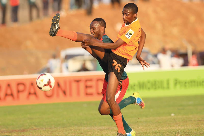 Gogontle Marumo(Orange) of Orapa United against Patrick Kaunda.PIC.KENNEDY RAMOKONE