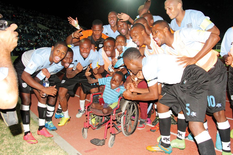 Zebras players celebrating their 2- 1 win against Mali with one of the supporters. PIC: KEOAGILE BONANG