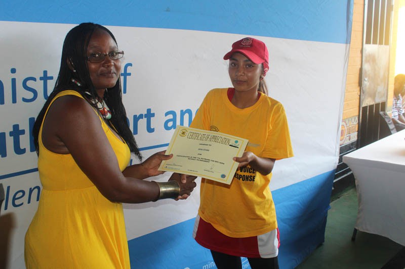 One of the tournament organisers, Malebogo Mophalane awarding a certificate to an outstanding player