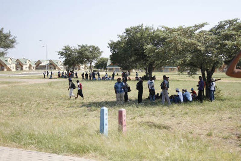 BIUST students waiting for the police to carry out the search for the bomb. PIC: KEOAGILE BONANG