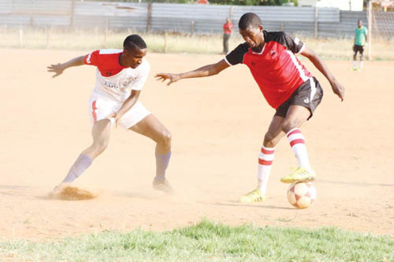 Rolling Boys' Omphile Madala (right) tries to beat Jwaneng Galaxy player during the two sides match on Saturday. PIC: KENNEDY RAMOKONE