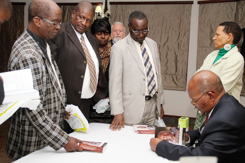Magang signs the book to those who bought copies.Pic:Kagiso Onkatswitse