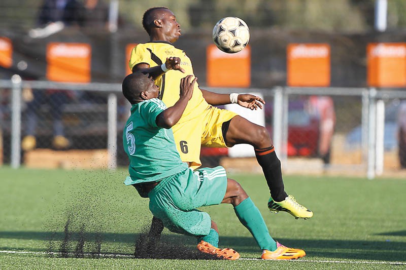 Mogami Makwatse of Prisons (in green) and Charles Ngosa. PIC: KENNEDY RAMOKONE