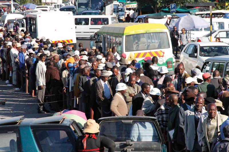 Former miners and their relatives at the bus rank early last year. PIC: KEBOFHE MATHE