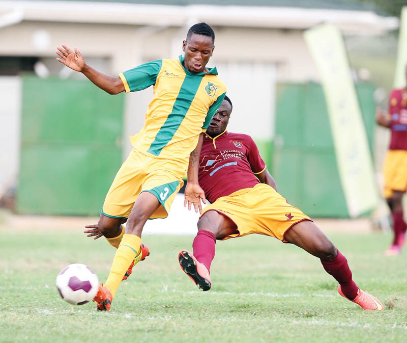 Police XI player, Ishmael Amponsah tackles ECCO City Greens' Gorata Keorapetse during the two sides' encounter on Saturday. PIC: KABO MPAETONA