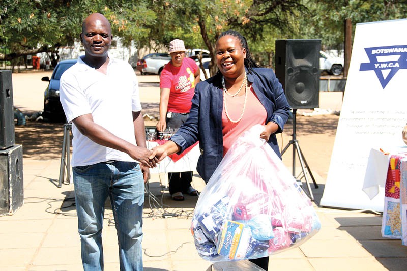 YWCA Principal Mr Chinguwa receiving sanitary pads