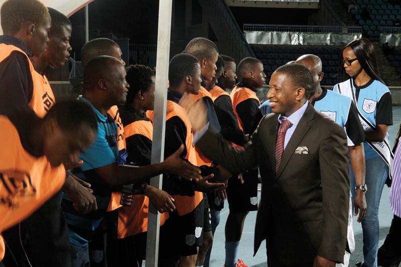 Under control: Sebego greets Under 23 players during Wednesday's friendly match against Lesotho
