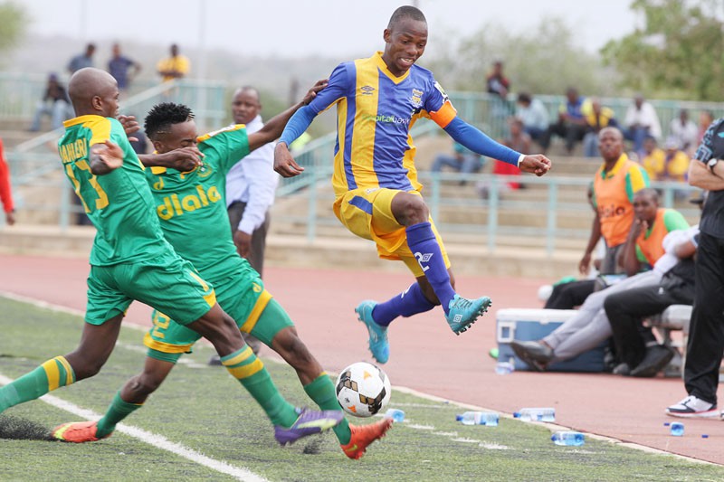 Maano Ditshupo (blue) attempts to tackle Green Lovers Players. PIC : KAGISO ONKATSWITSE