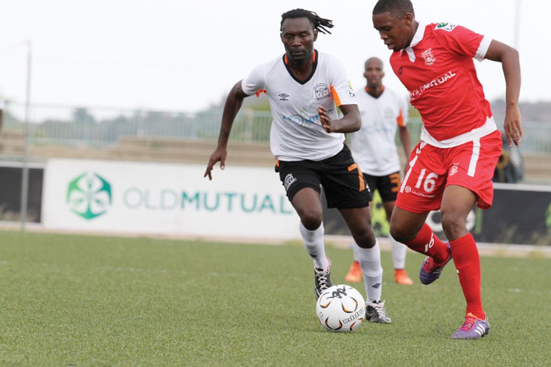 Goal scorer, Ronald Chikomo (left) monitors GU defender, Thabiso Khunwane PIC: MORERI SEJAKGOMO