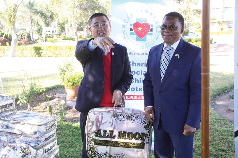 Miles Nan handing over blanckets to Vice President Slumber tsogwane.PIC:KENNEDY RAMOKONE