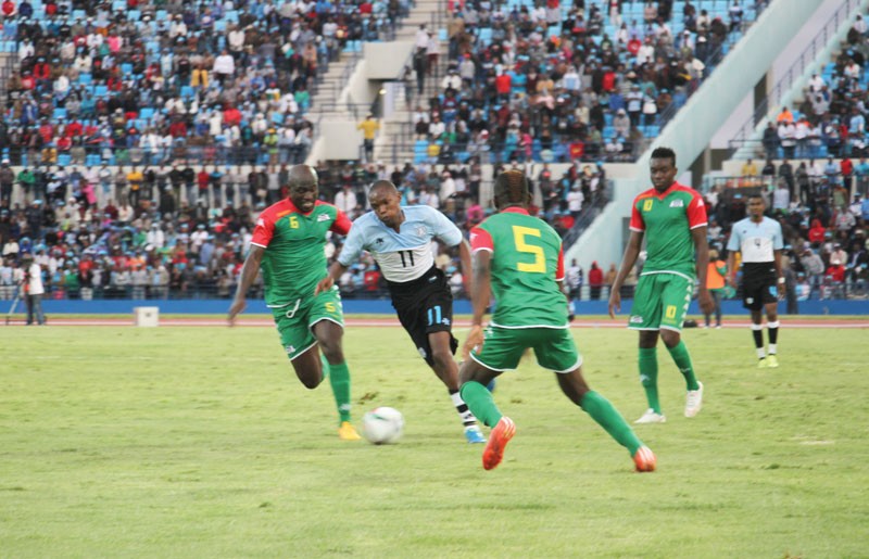 Tsotso Ngele making his way through Burkina Faso players Koffi Mahomed (5) and Kone Djakaridja (6). PIC: KEOAGILE BONANG
