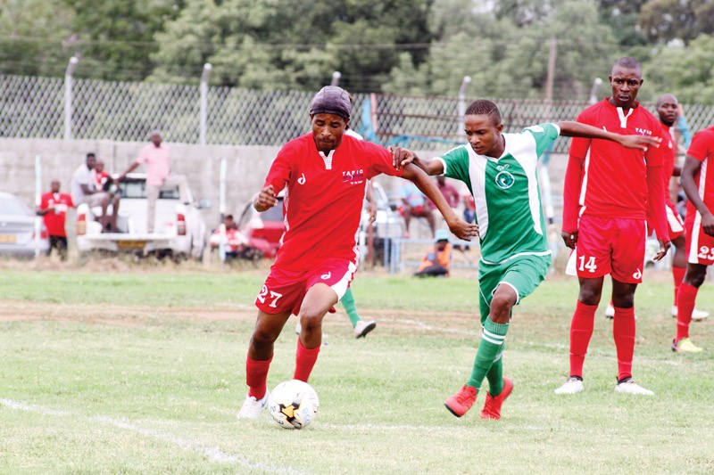 Rockie Nkwe of TAFIC and Kenny Tarea of City Greens during the Debswana First Division North game that TAFIC won by 3 goals to 2 PIC: KEOAGILE BONANG