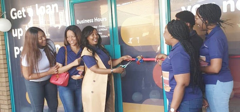 Dineo Saleshando (brown coat) officially opening Express Credit at Lobatse