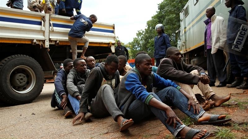 People arrested during protests wait to appear at the magistrate's court in Harare PIC: Philimon Bulawayo/Reuters
