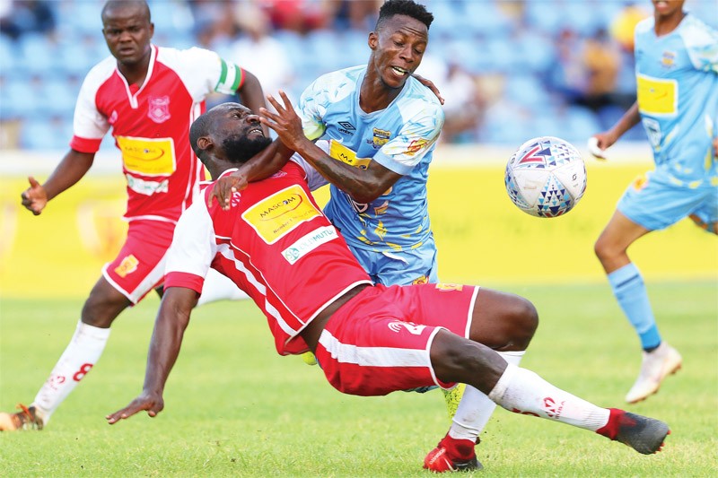 Rentse Keakabetse (red) of Gaborone United vying for the ball with Mothusi Cooper of Township Rollers PIC: KENNEDY RAMOKONE
