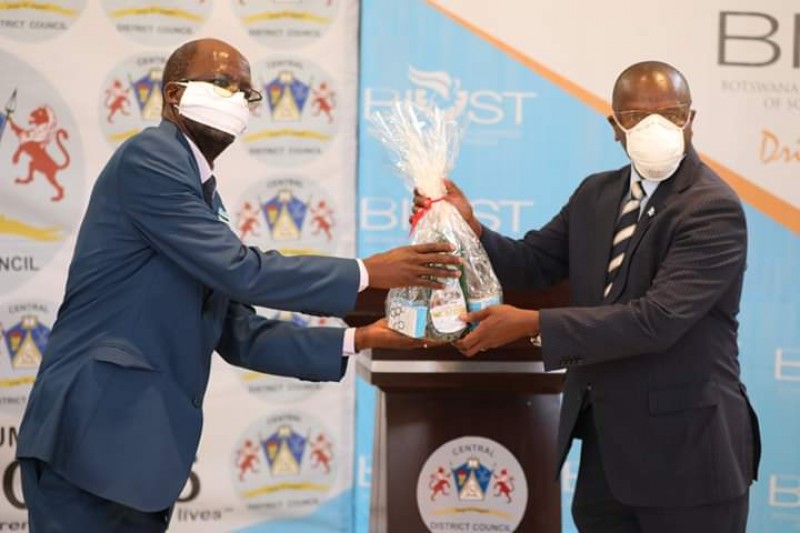BIUST vice chancellor Prof Otlogetswe Totolo handing over 1700 bar soaps and 4000 liquid soap to Serowe community